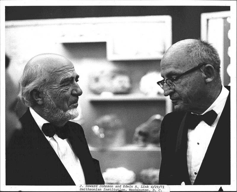 A black and white photo of two men conversing