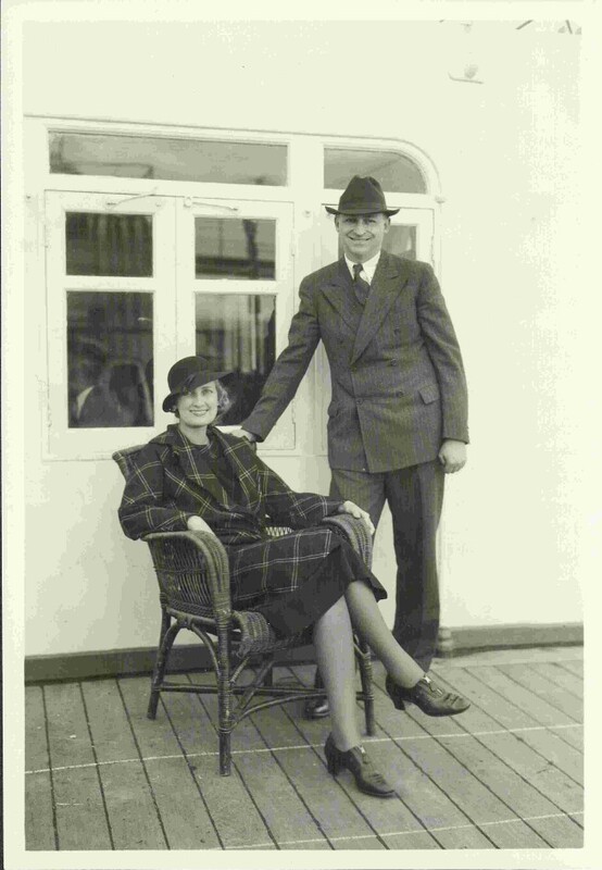 An old photograph of a woman, Marion Link, sitting in a chair and a man, Edwin A. Link, standing besides her
