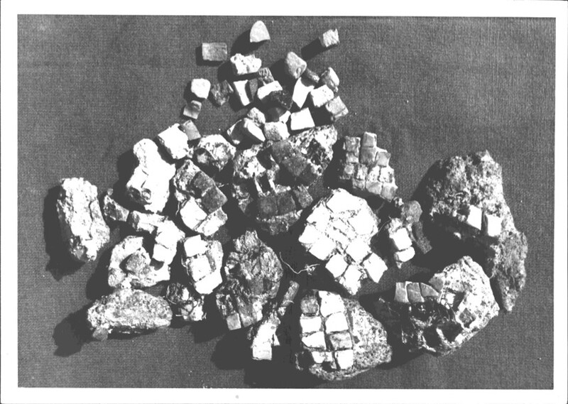 A black and white photograph of pieces of a mosaic tiles