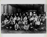 A black and white photograph of a group of employees