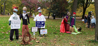 Scarecrows wearing masks at the 2020 Scarecrow Display and Contest at Otsiningo Park