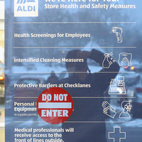 Aldi's sign on the exit door outlining the store health and safety measures with photographer's reflection superimposed, along with the prominent red "DO NOT ENTER" sign