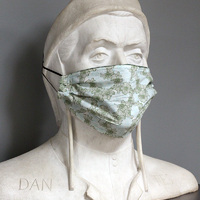 A large white marble sculpture of Dante wearing the light green floral side of a fabric mask