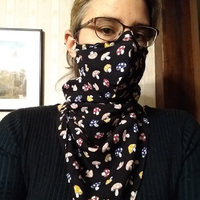 Librarian Neyda in a scarf mask that she made out of an old dress with a cute mushroom print on it